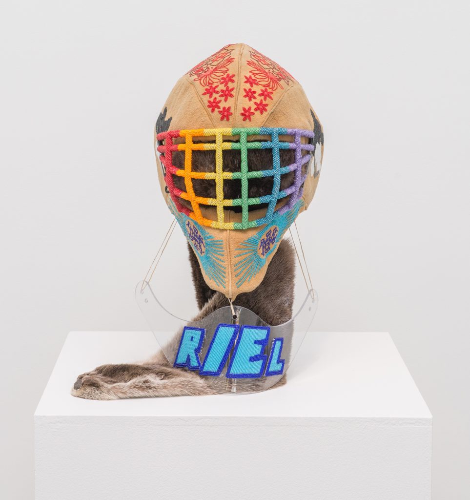 Judy Anderson, <em>This one brings me the most pride…</em>, 2017. Mixed-media sculpture with beads, moose hide, otter skin, goalie helmet. Photo: Andrew Barcham.