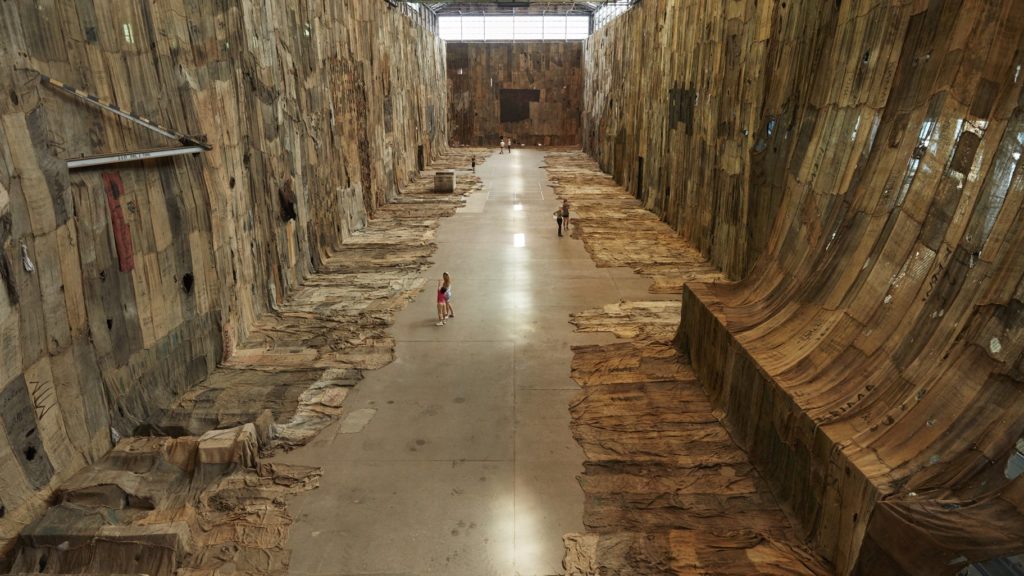 Ibrahim Mahama, <em>No Friend but the Mountains 2012-2020</em>, 2020. Charcoal jute sacks, metal tags and scrap metal tarpaulin, dimensions variable. Installation view for the 22nd Biennale of Sydney, Cockatoo Island. Courtesy the artist; White Cube; and Apalazzo Gallery, Brescia. Photograph: Zan Wimberley