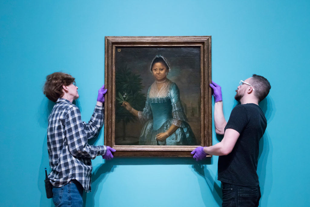 Art Gallery of Ontario staff installing <em>Portrait of a Lady, Three Quarter Length, Holding an Orange Tree Flower</em>, a newly acquired painting by an unknown European artist from the mid-18th century. Photo: AGO.
