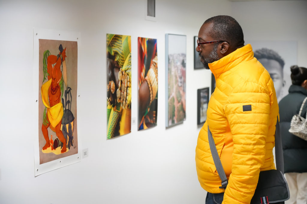 A visitor considers some of the work at Nia Centre’s 2019 event A Black Art Fair. Photo: CJ Cromwell. Courtesy Nia Centre.