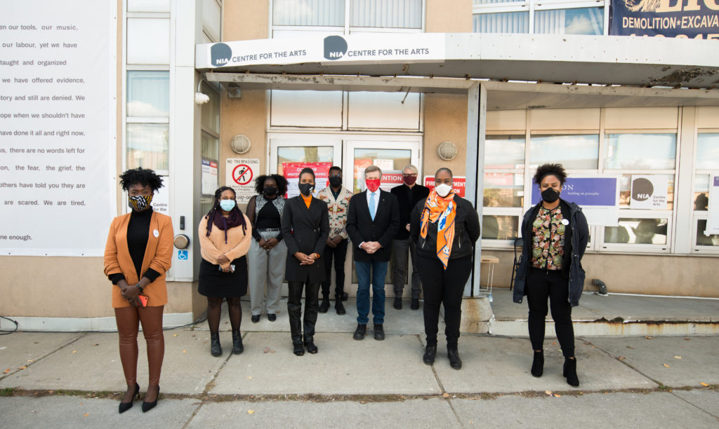 Members of the Nia Centre team stand with government officials at a press  event on October 16 at 524 Oakwood. Left to right: Adom Acheampong, program manager; Lidia Abraha, digital content coordinator; Sanique Walters, program coordinator; Alica Hall, executive director; Michael Braithwaite, board co-chair; John Tory, mayor of Toronto; Adam Vaughan, MP for Spadina–Fort York; Jill Andrew, MPP for Toronto–St. Paul’s; and Chantel Guthrie, youth program manager.