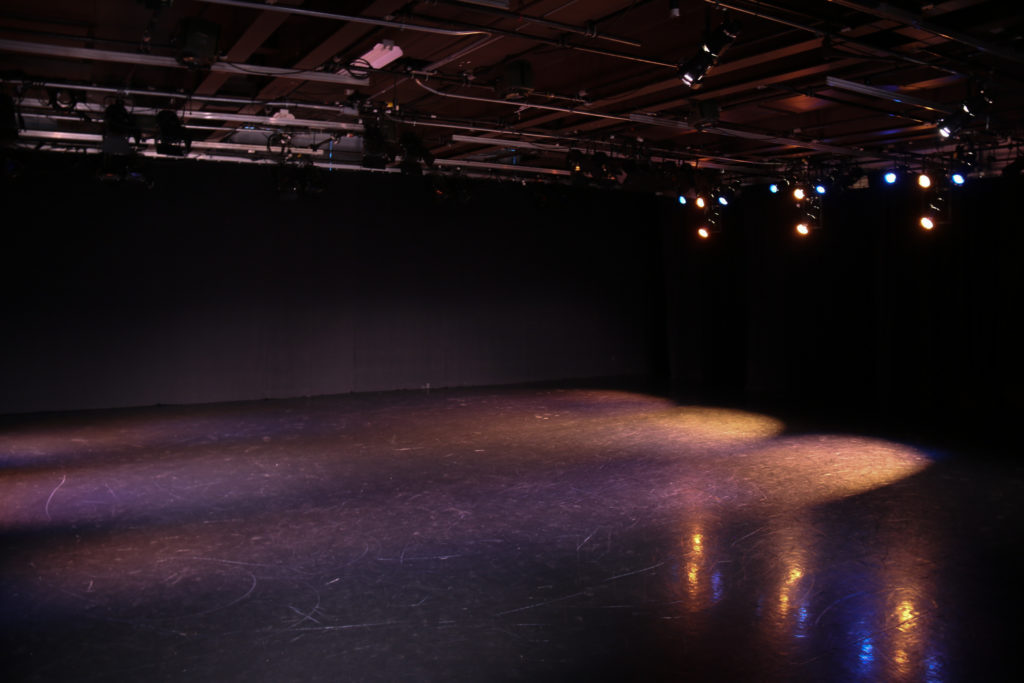 An empty stage with theatre lighting